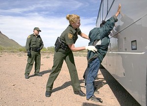 CBP Border Patrol agent does a pat down of a female Mexican being returned to Mexico.